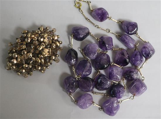 An amethyst pebble bead necklace and a Christian Dior brooch signed and numbered 1960, with original box and pouch.
